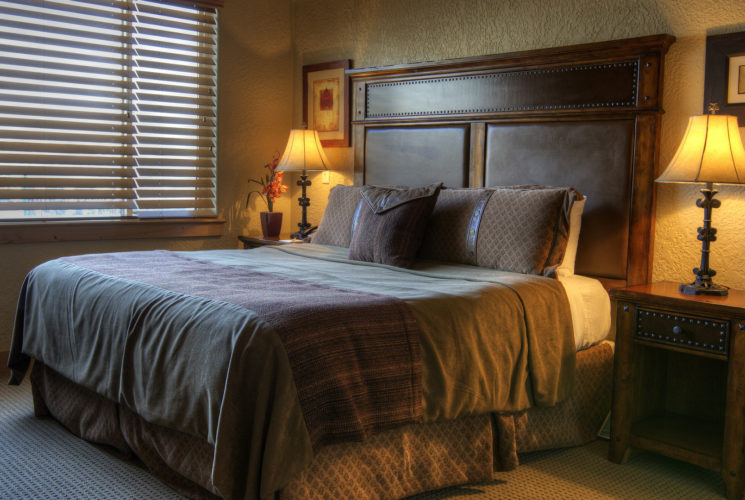 Bedroom with dark wooden bed and furniture